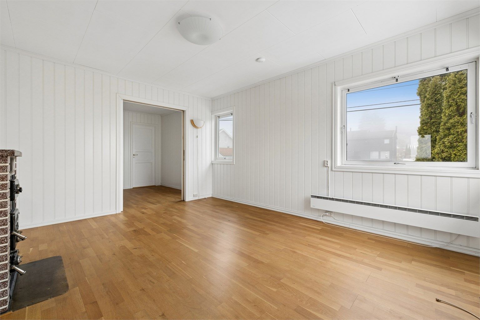 Stuen i andre etasje har parkett på gulvet og malte panelplater på veggene.