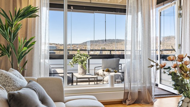 Med store vindusflater føles balkongen som en forlengelse av stuen og skaper en lys og luftig atmosfære. Foto: Trond Reder.