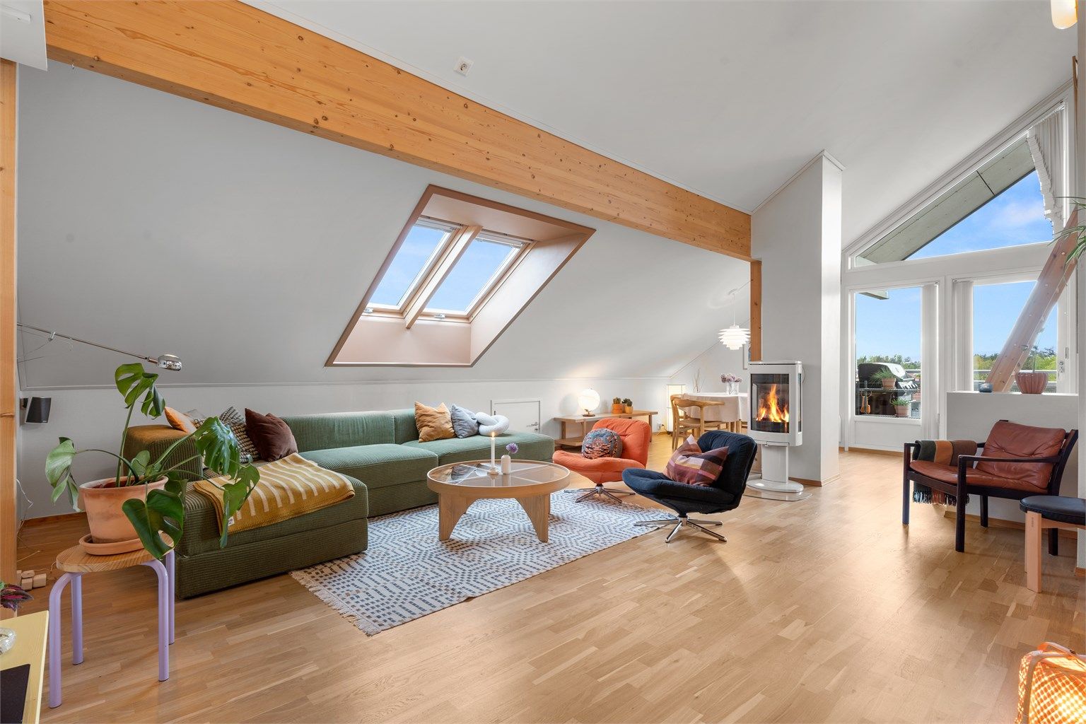 Det er store vindusflater som slipper inn rikelig med lys og skaper en lys og luftig atmosfære i stuen. Velux-vindu i tak blir byttet ut i regi borettslag. 