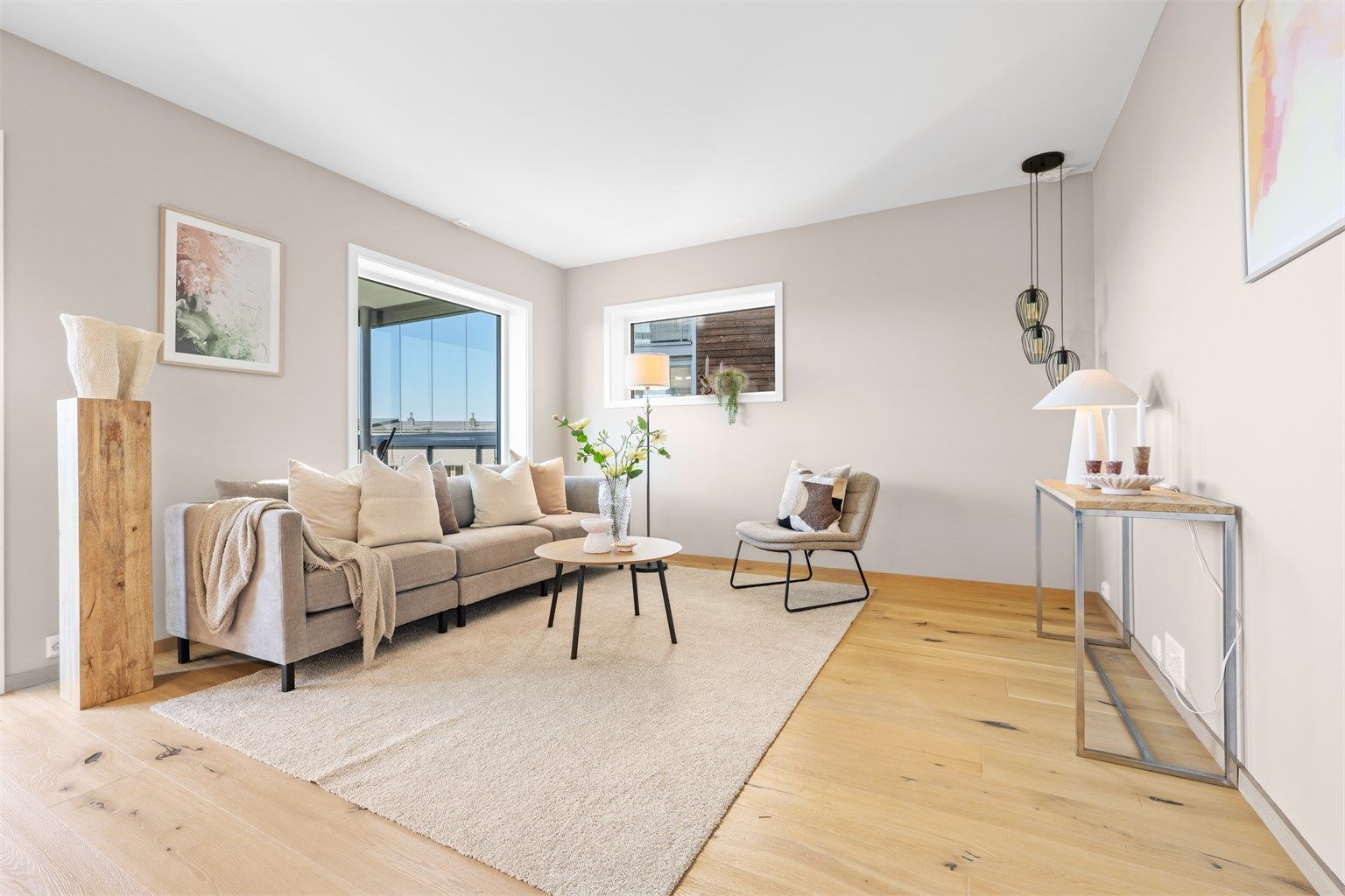 Romslig stue med 1-stavs parkett på gulv og nymalte slette vegger