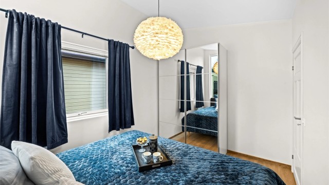 En stor skyvedørsgarderobe med speilfronter gir rikelig med oppbevaringsplass.