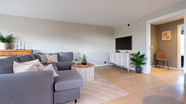 Overflatene er malt i en behagelig og moderne fargetone, og på gulvet er det lagt parkett.