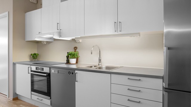 Sigdal kjøkkeninnredning med lyse glatte fronter - hvitevarene følger med.