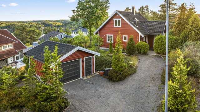 Frittliggende enebolig med tilbaketrukket beliggenhet øverst i Rismyrfeltet og frittstående garasje.
