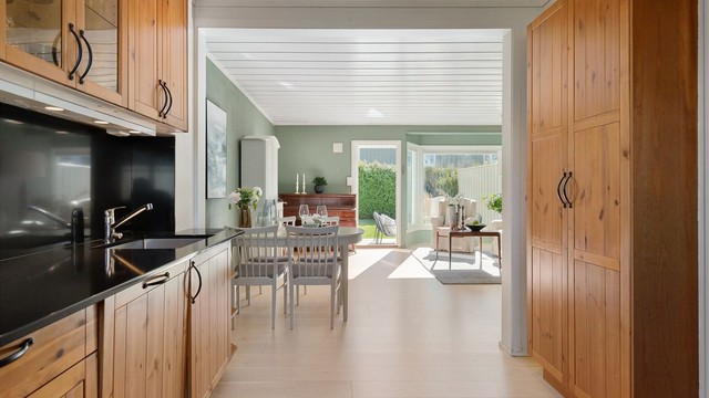 Fra kjøkkenet er det en åpen og sosial forbindelse til stuen og spiseplassen.