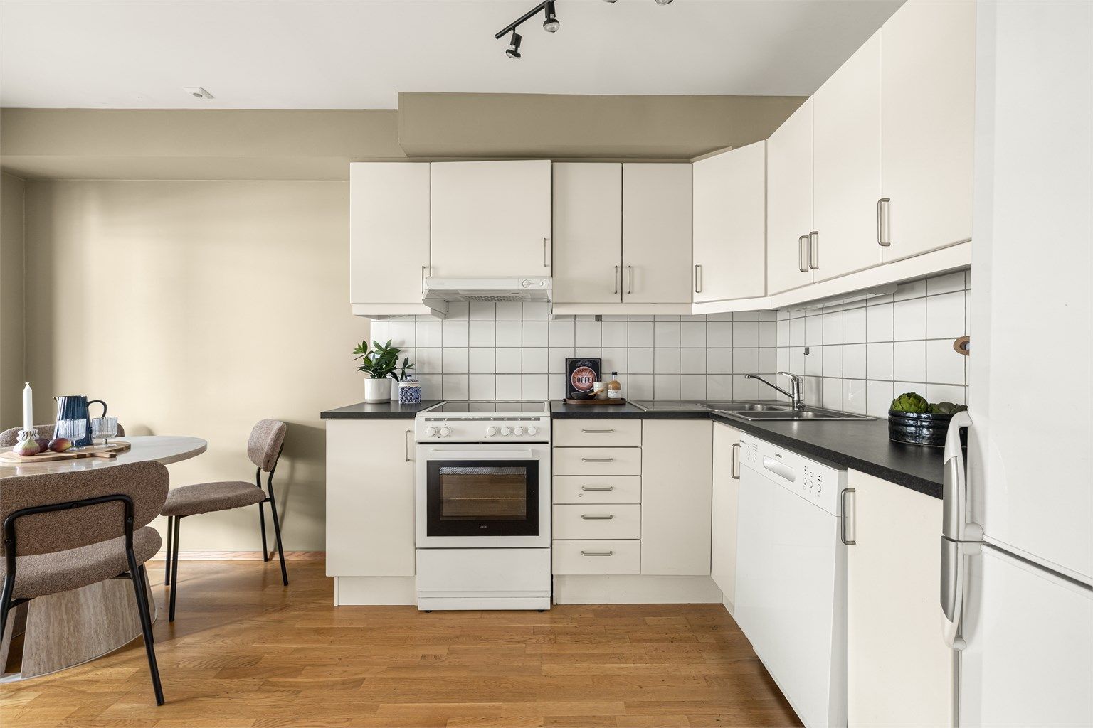 Praktisk vinkelkjøkken som utnytter plassen godt og gir en åpen følelse mot stuen.