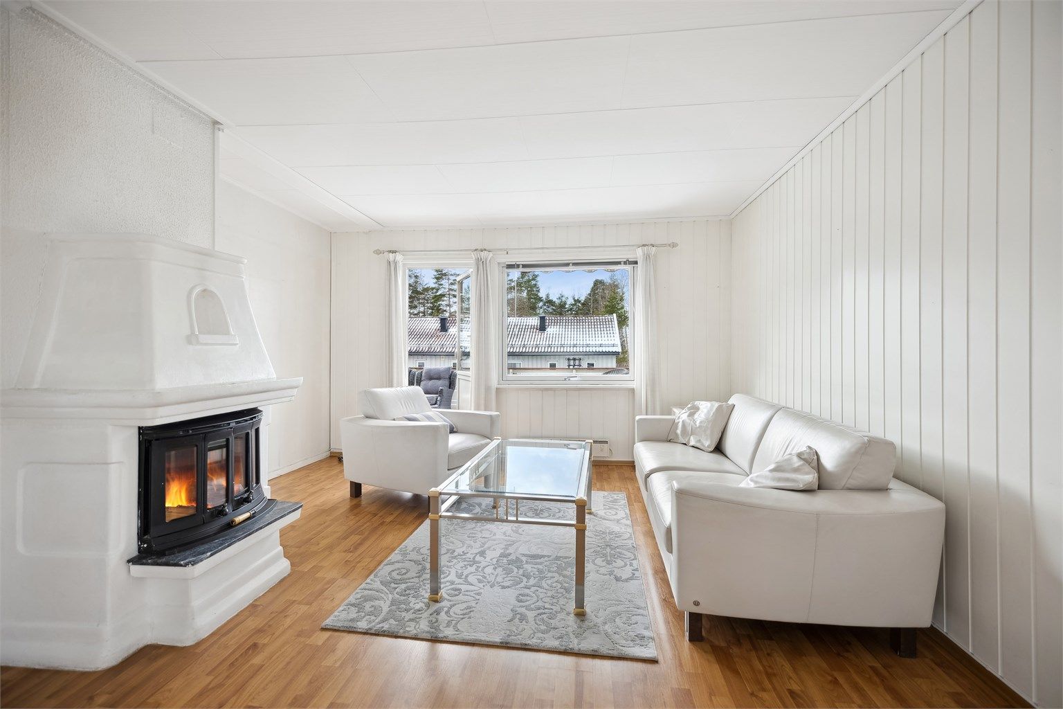 Lys og hyggelig stue med plass til sofagruppe og spiseplass. En fin peisovn gir god varme og en koselig atmosfære på kjølige kvelder