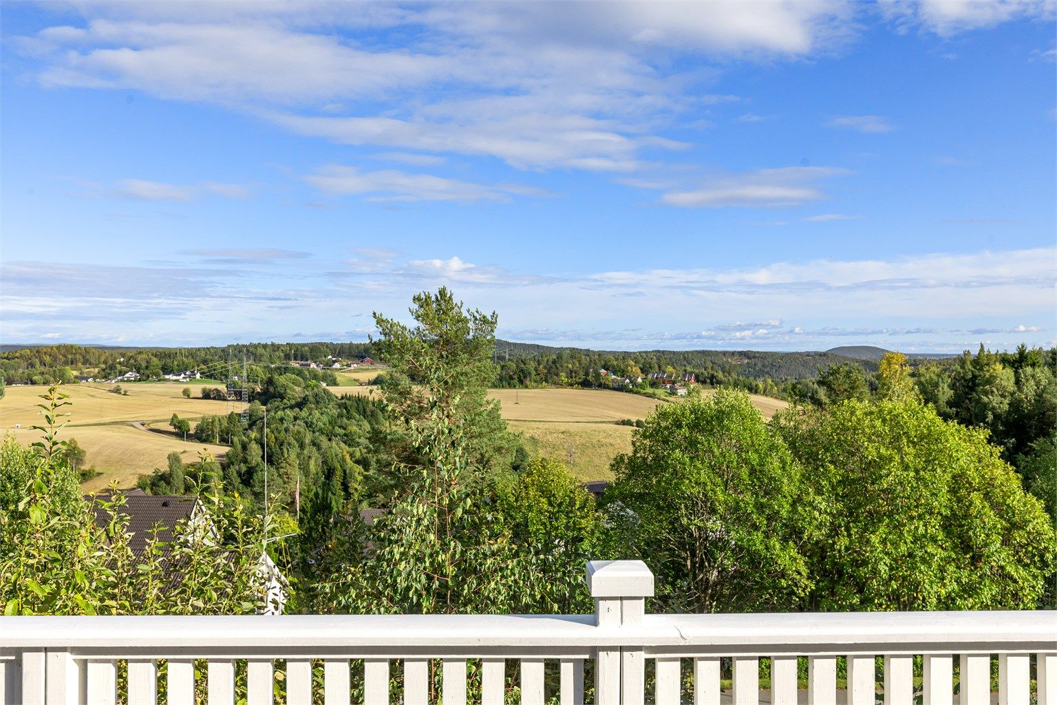 Frittliggende enebolig over to plan med skjermet hage og stor terrasse like ved Kjekstadmarka. Flott utsyn over frodige jorder, skogkledde åser og det åpne landskapet. Foto: [Eiendomsfoto AS]