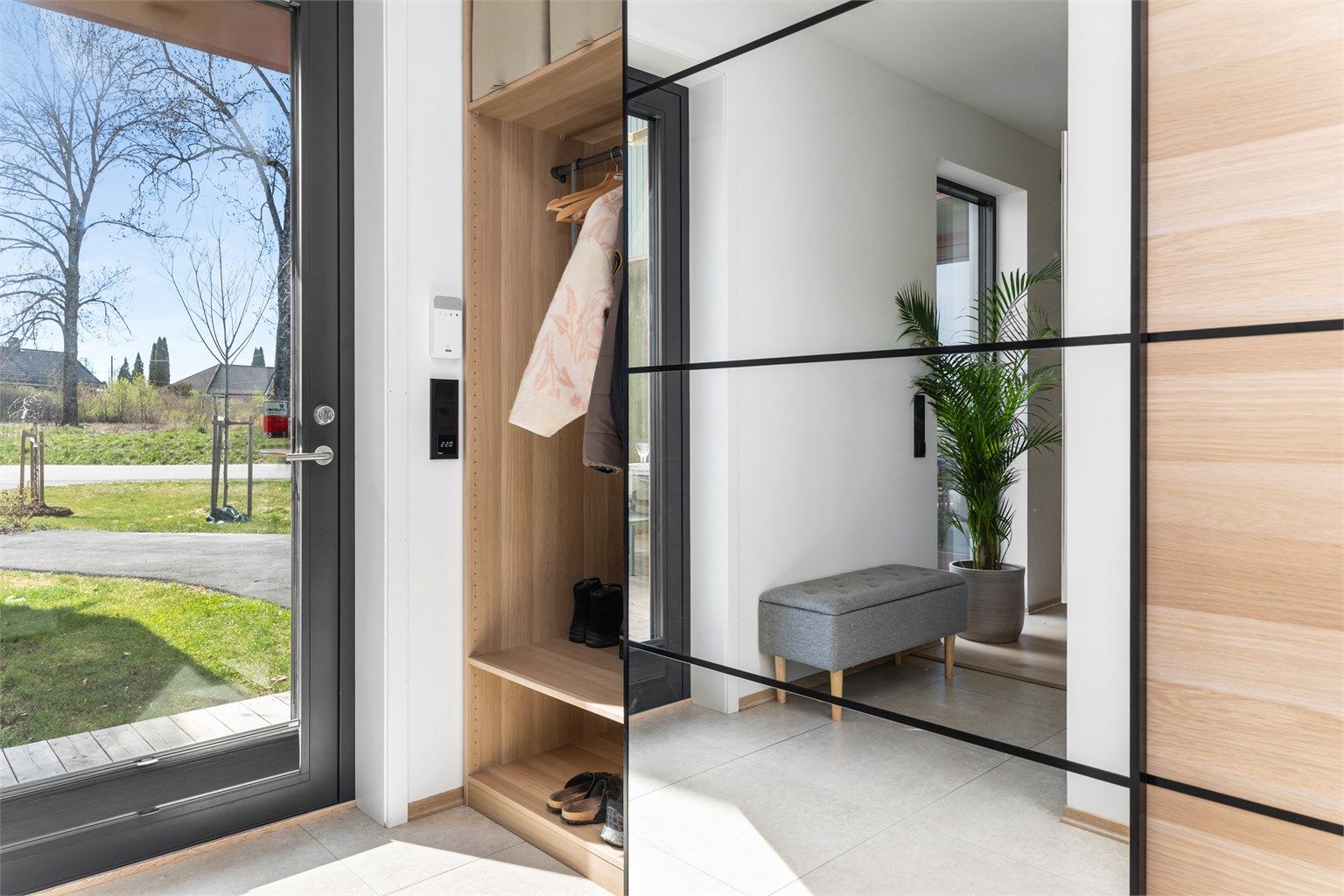 Entréen har flislagt gulv med gulvvarme og en praktisk garderobeløsning.