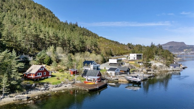 Eiendommen består av en fritidsbolig, et separat anneks og et romslig naust, alt samlet i et idyllisk tun ved sjøen.