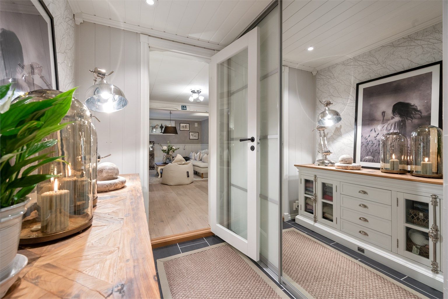 Glassdører skiller gangen fra kjellerstuen og slipper lyset gjennom