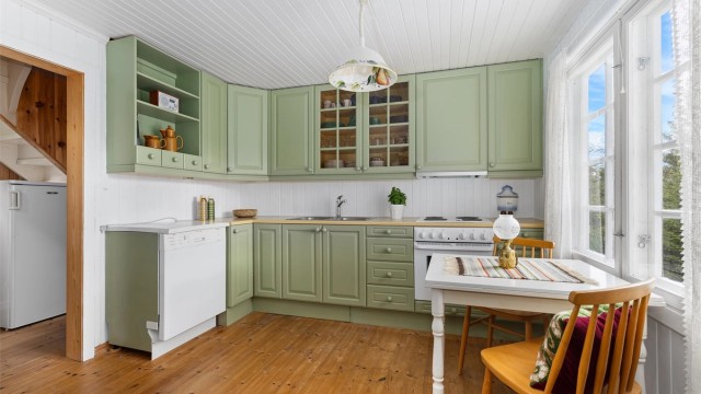 Godt utstyrt kjøkken med plass til spisebord.
