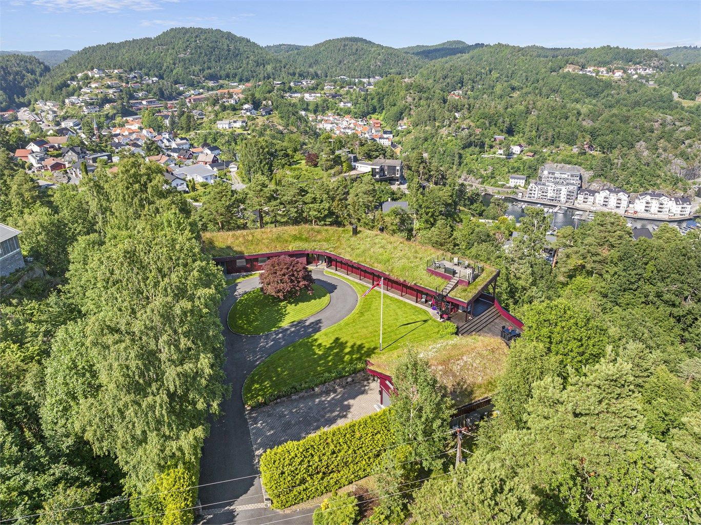 Lekkert, parkmessig opparbeidet uteområde med flere uteplasser.