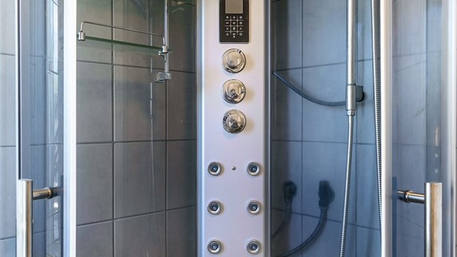 Dusjkabinettet er utstyrt med et moderne dusjpanel.