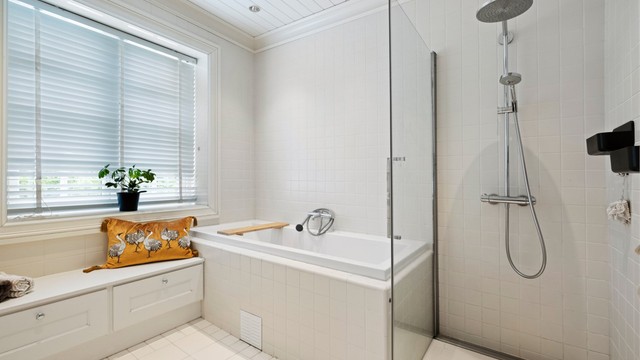 Badet er utstyrt med et innfliset badekar fra Duravit og et separat dusjhjørne med vegghengt dusjarmatur hånd hånddusj og regndusj