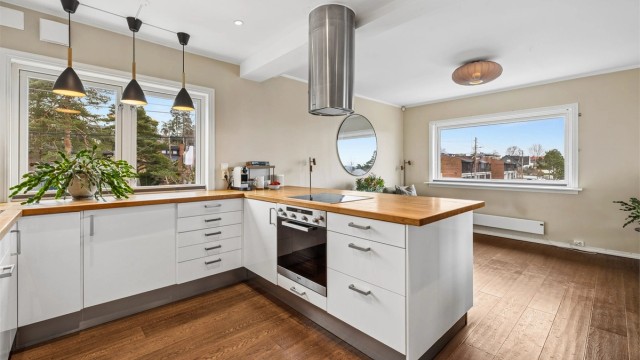 Den praktiske kjøkkenøya gir ekstra arbeidsflate og en naturlig soneinndeling mot stuen.