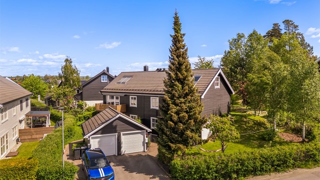 Garasje - 1/2 del av dobbelgarasje plassert i tomtegrense med nabo i nr. 28 - plass til en bil samt plass til parkering på egen gårdsplass - elbil-lader medfølger