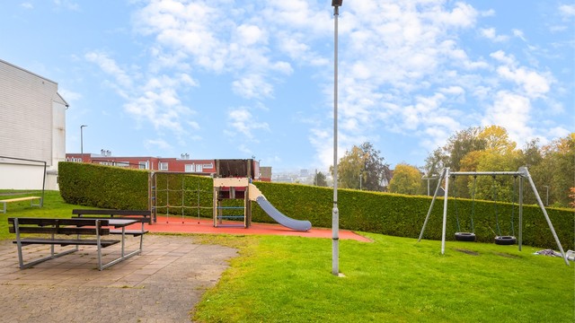 Felles lekeplass med husker, sklie og sittebenker ligger bare et steinkast unna, en populær møteplass for både små og store i nabolaget.