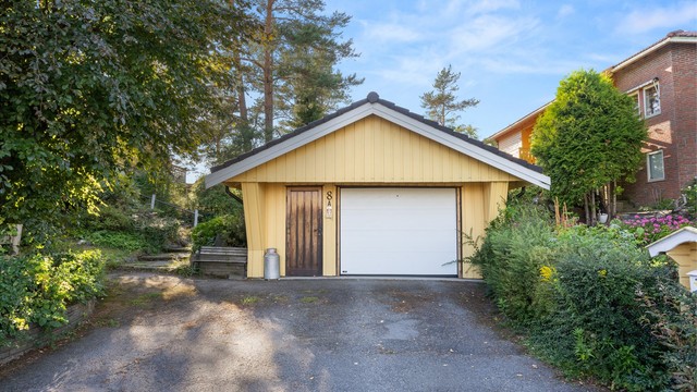Frittstående garasje med leddport med portåpner, samt oppstillingsplasser på egen tomt.