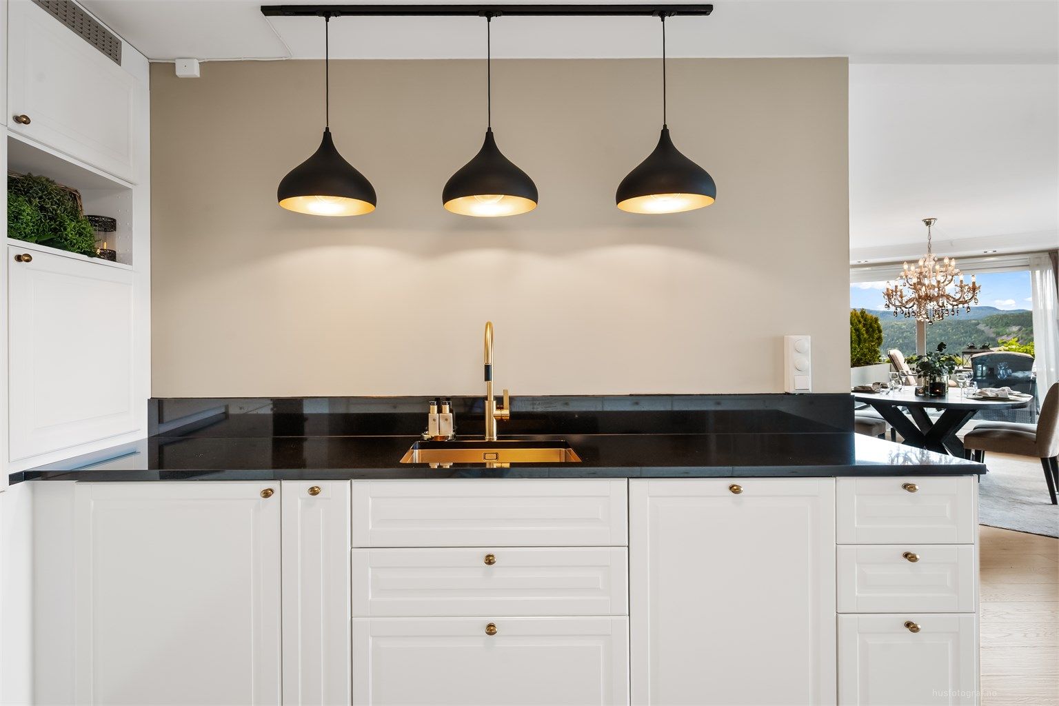 Profilert og elegant IKEA-kjøkkeninnredning fra 2023 i en klassisk hvit utførelse med sorte- samt rustikke detaljer som gir en fin kontrast.