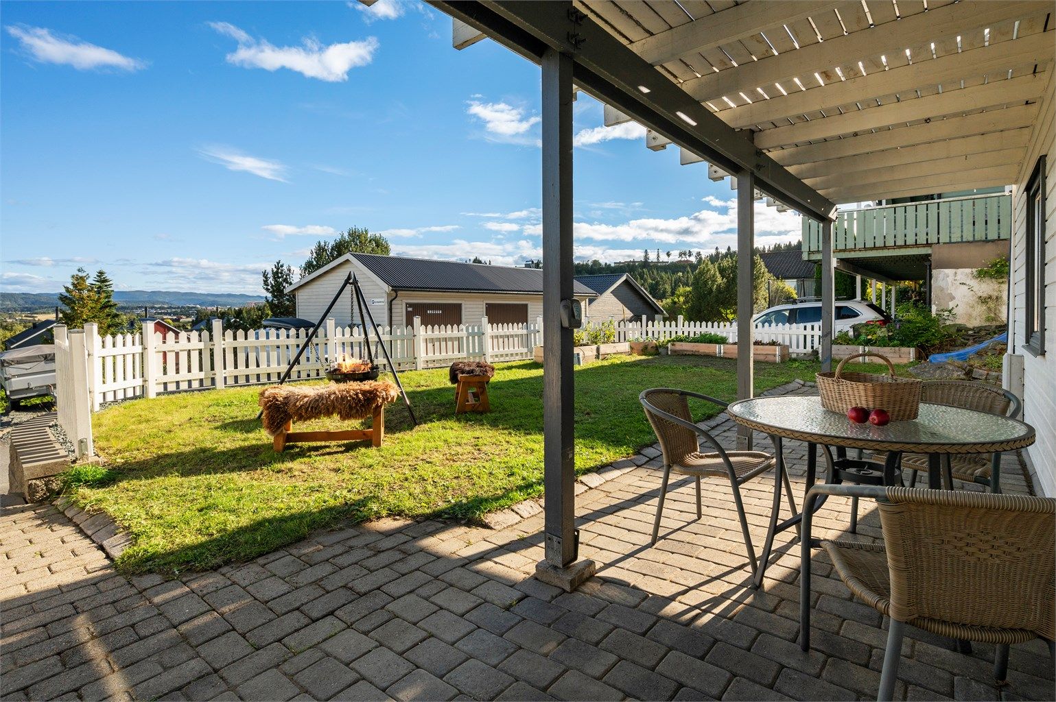 Garasjen er plassert like nedenfor huset, og i tillegg er det flere biloppstillingsplasser som nabolaget deler i fellesskap. 