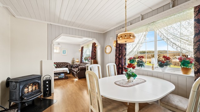 Ildstedet i spisestuen gir både varme og en hyggelig atmosfære på kjølige dager.