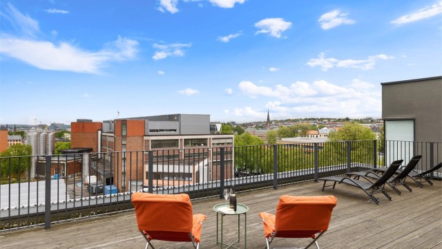 Beboerne har tilgang til en stor, solrik takterrasse med utsikt over byens tak.