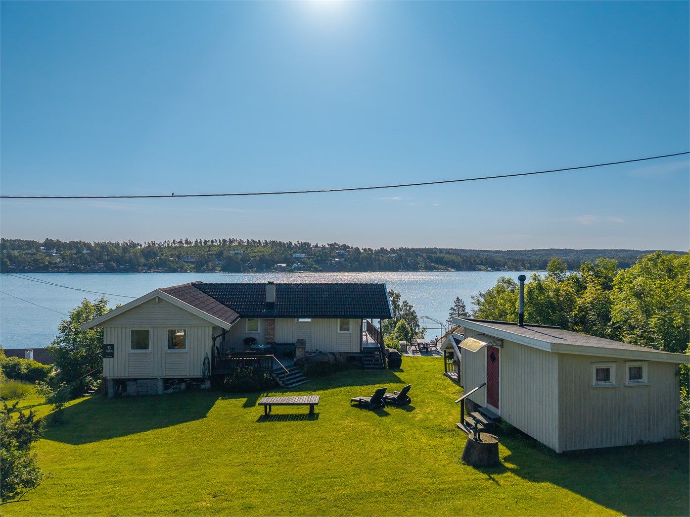 Fra bygningene og tomten generelt er det fantastisk sjøutsikt og tomten grenser helt ned i vannkanten med egen strand. (Terrasse ved inngangsparti er noe utvidet i forhold til byggemeldt tegning)
