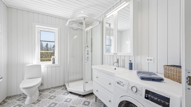 Bad og vaskerom fra 2021 i tilbygget. Rommet har flislagt gulv med gulvvarme, dusjkabinett og opplegg for vaskemaskin. Vaskemaskin følger med.