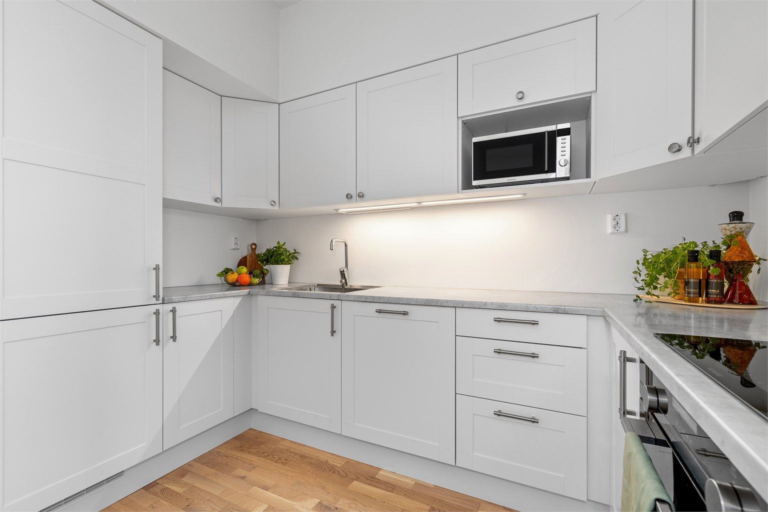 God belysning under overskapene gir et funksjonelt og behagelig arbeidslys.