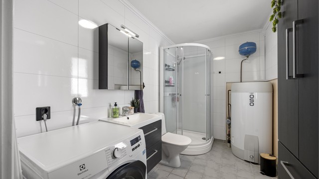 Badet i første etasje har flislagt gulv med elektriske varmekabler. Ny varmtvannstank 2026.