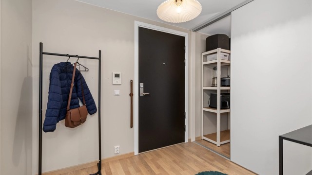 Innbydende og romslig entré med skyvedørsgarderobe for bedre orden og bedre oppbevaringsplass i hjemmet.