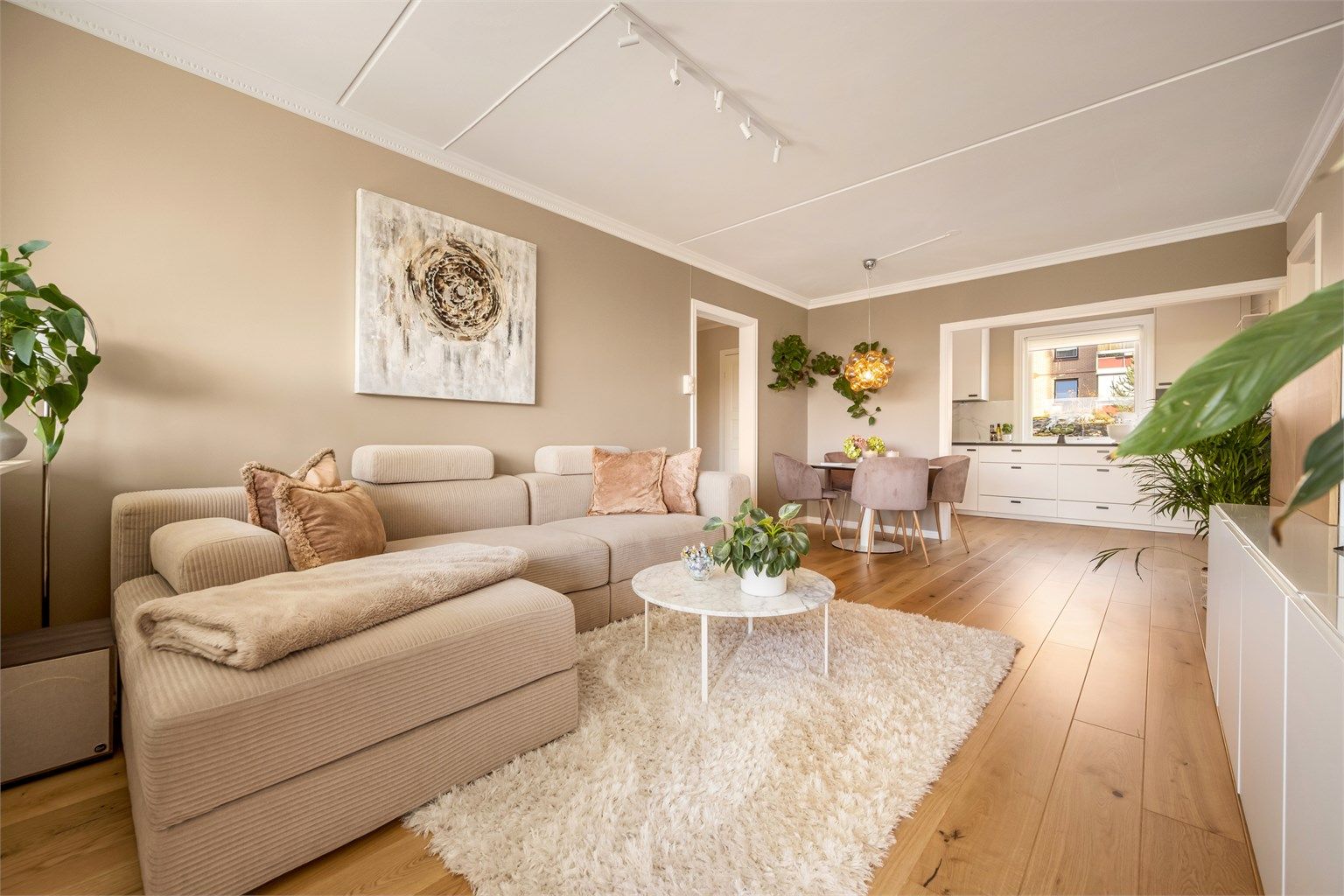 Stuen har parkettgulv, radiator tilknyttet fellesanlegg og god plass til både sofagruppe og spisebord. Foto: Martine Eren Jacobsen