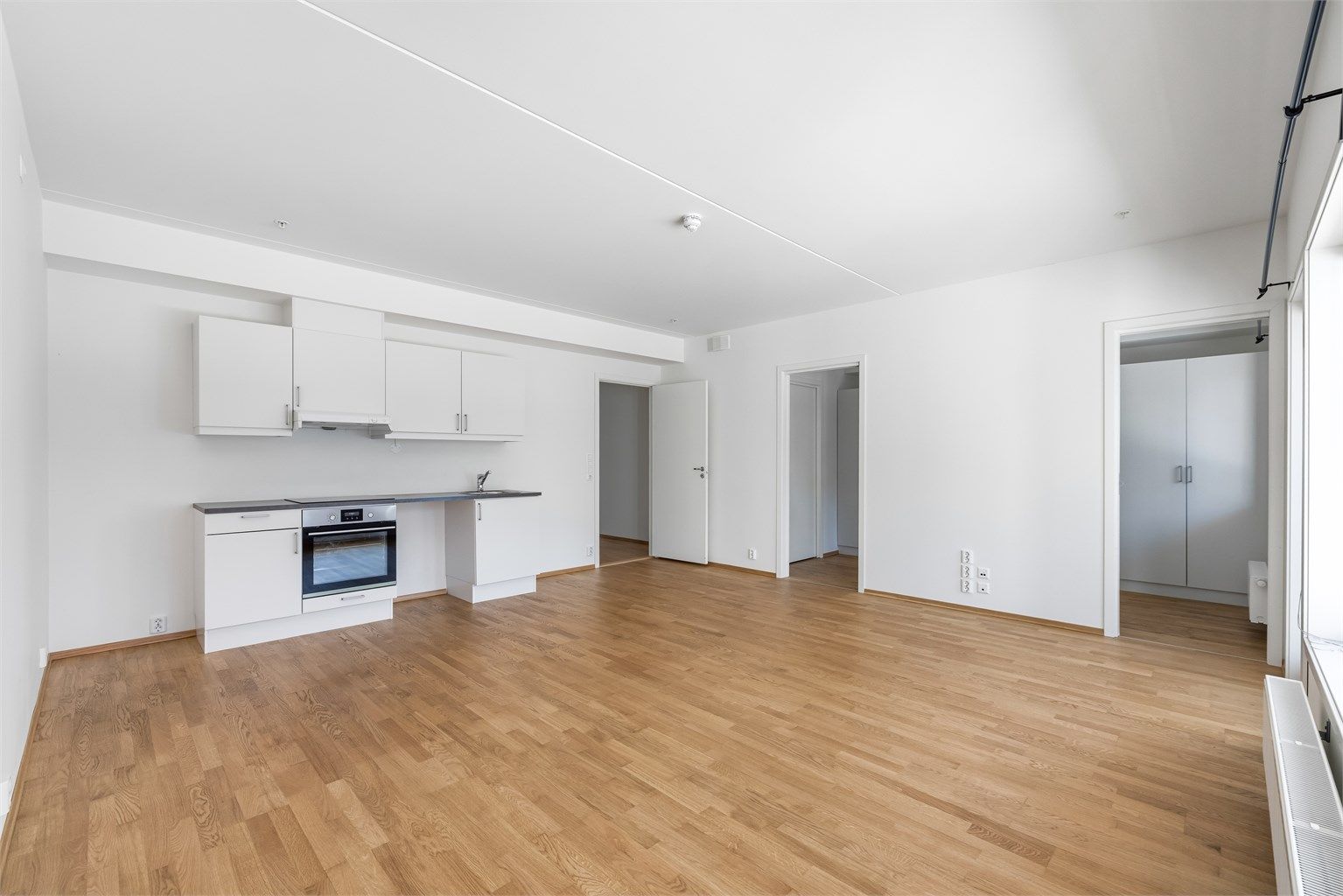 Kjøkkenet er lyst og praktisk, og innredet med glatte fronter og benkeplate i laminat.