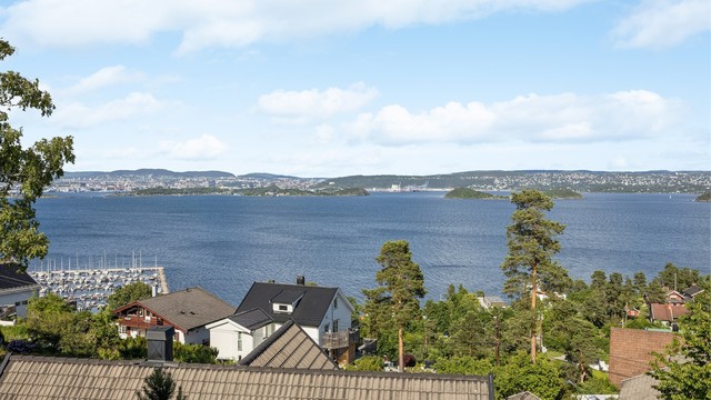 Fra terrassen og oppholdsrommene kan du følge livet på fjorden og nyte den vidstrakte utsikten mot hovedstaden.