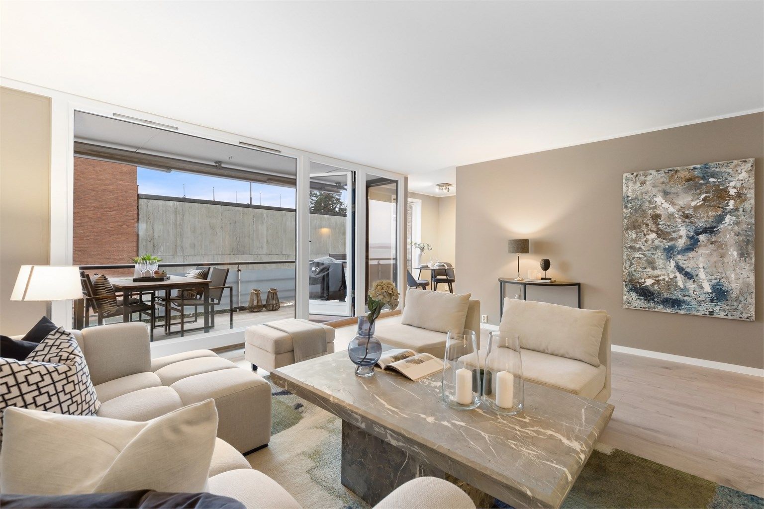 De brede balkongdørene kan åpnes helt, og integrerer uteplassen med stuen på fine dager.