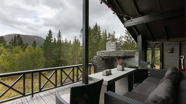 Murt utepeis i naturstein under det overbygde taket på terrassen.
