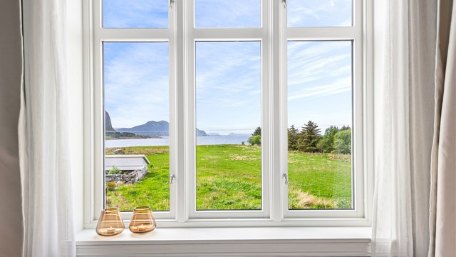 Fra loftsetasjen er det flott utsikt over det omkringliggende landskapet og sjøen.