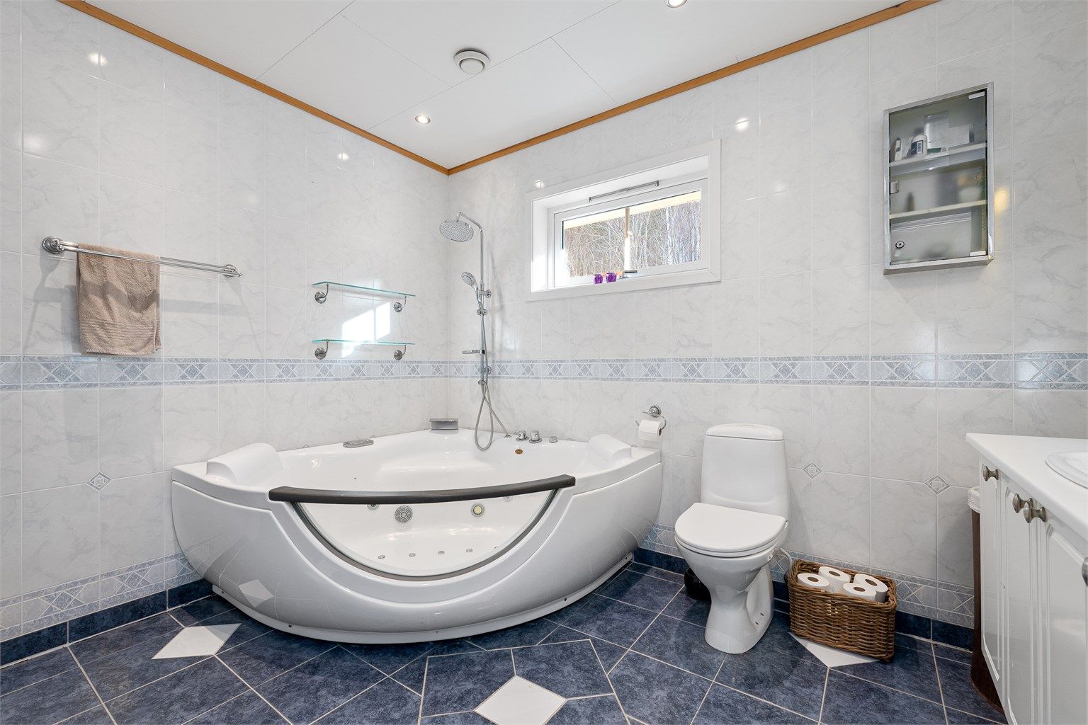 Bad i hovedetasjen med hjørnebadekar med massasjedyser 