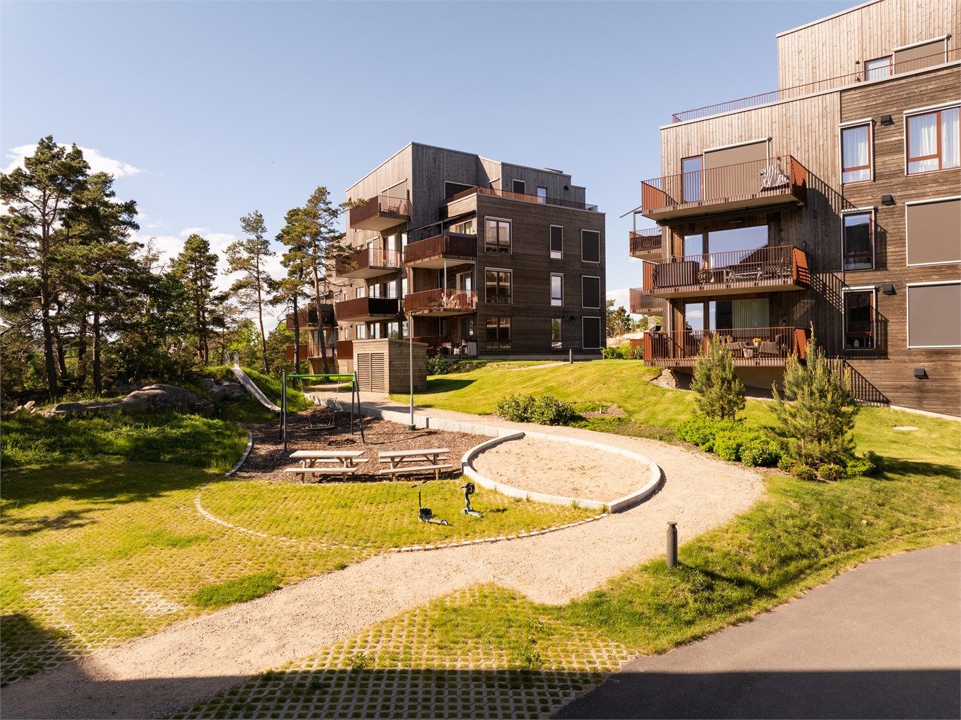 Både materialvalg på fasadene og de grønne fellesarealene i Haraldåsen spiller på lag med skogsområdene omkring.
