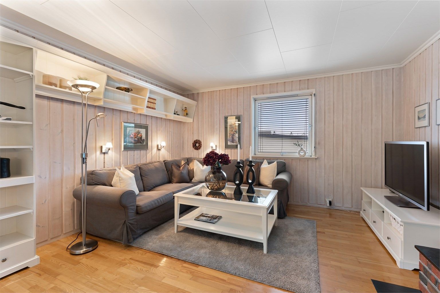 Plassbygde hyller gir smart oppbevaring og en fin ramme rundt sofakroken.