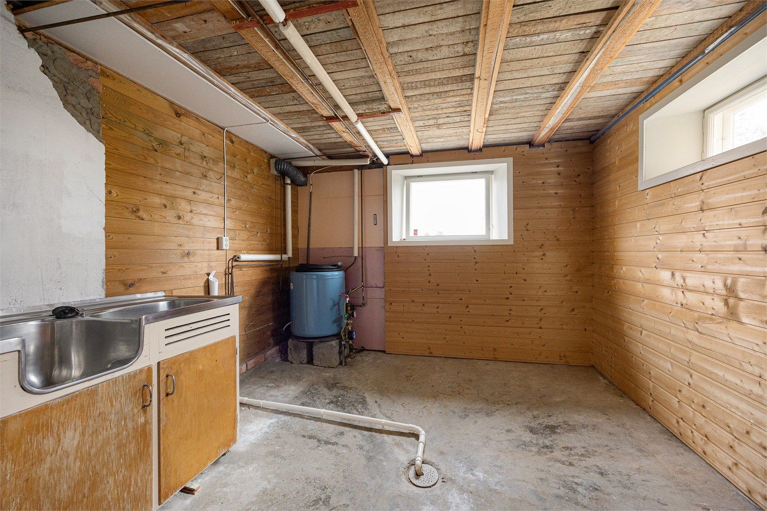 Vaskekjeller i underetasjen med opplegg for vaskemaskin og utslagsvask.