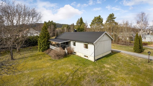 Velkommen til Vollafaret 4! En enebolig fra 1967 med en romslig og tilnærmet flat tomt, opparbeidet med gressplen og beplantning. Foto: Svein Michaelsen