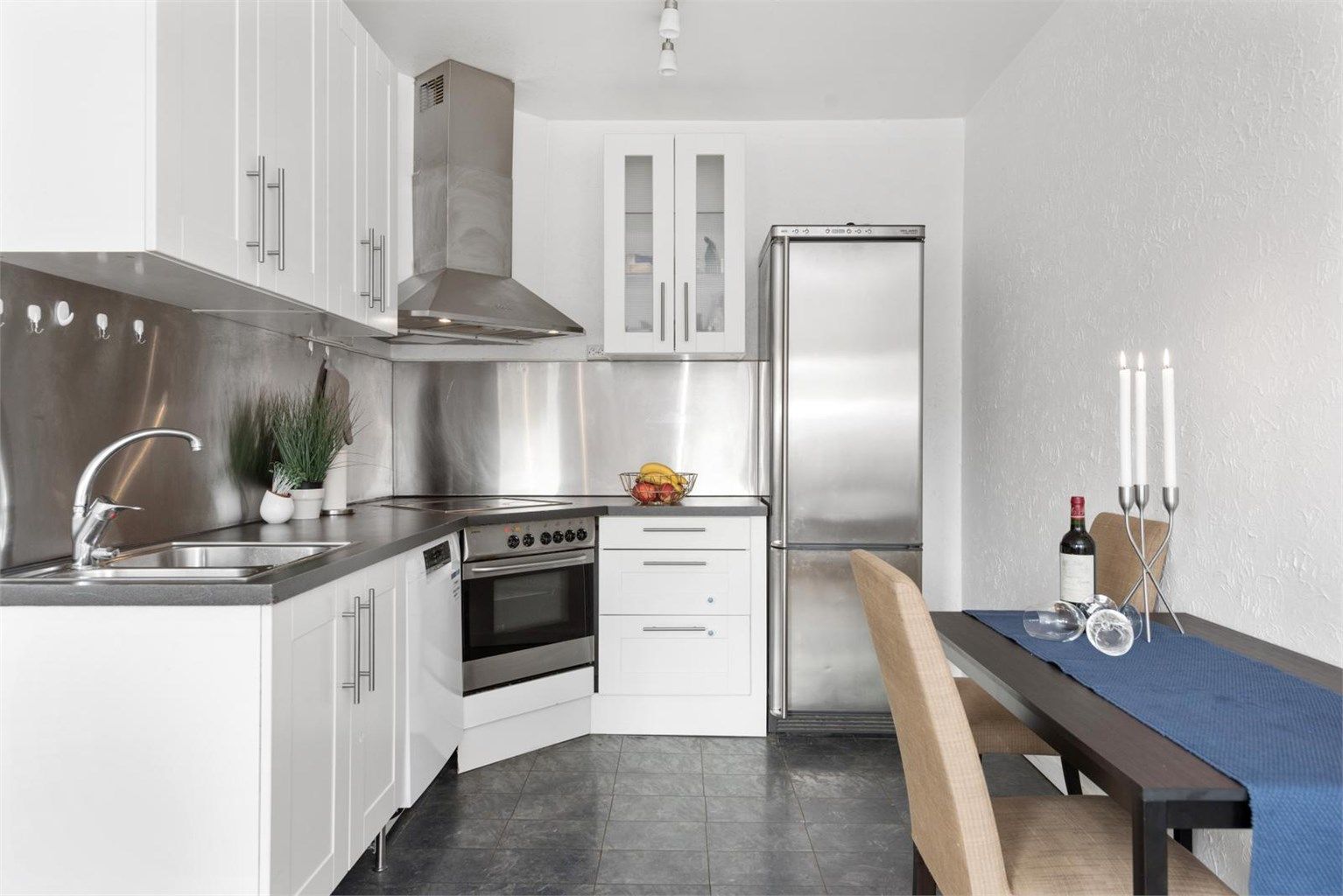 Kjøkken med åpen løsning mot stuen. Plass til liten spisegruppen i stuen.