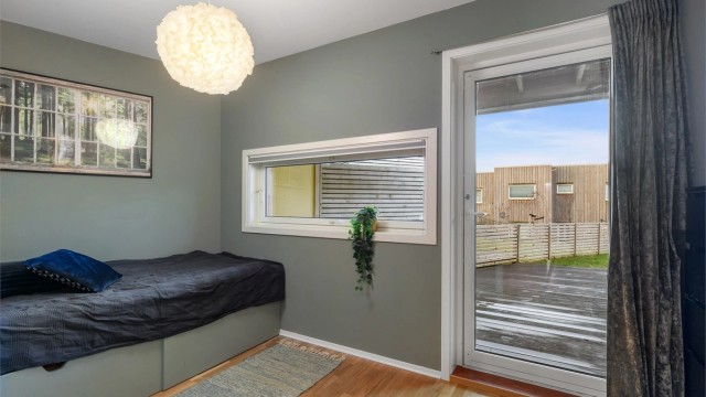 Soverom i 1. etasje med god plass til seng og direkte utgang til markterrasse med solrike forhold.