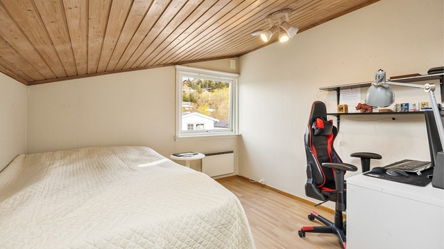 Panel i himling og skråtak gir en lun atmosfære på flere av soverommene.