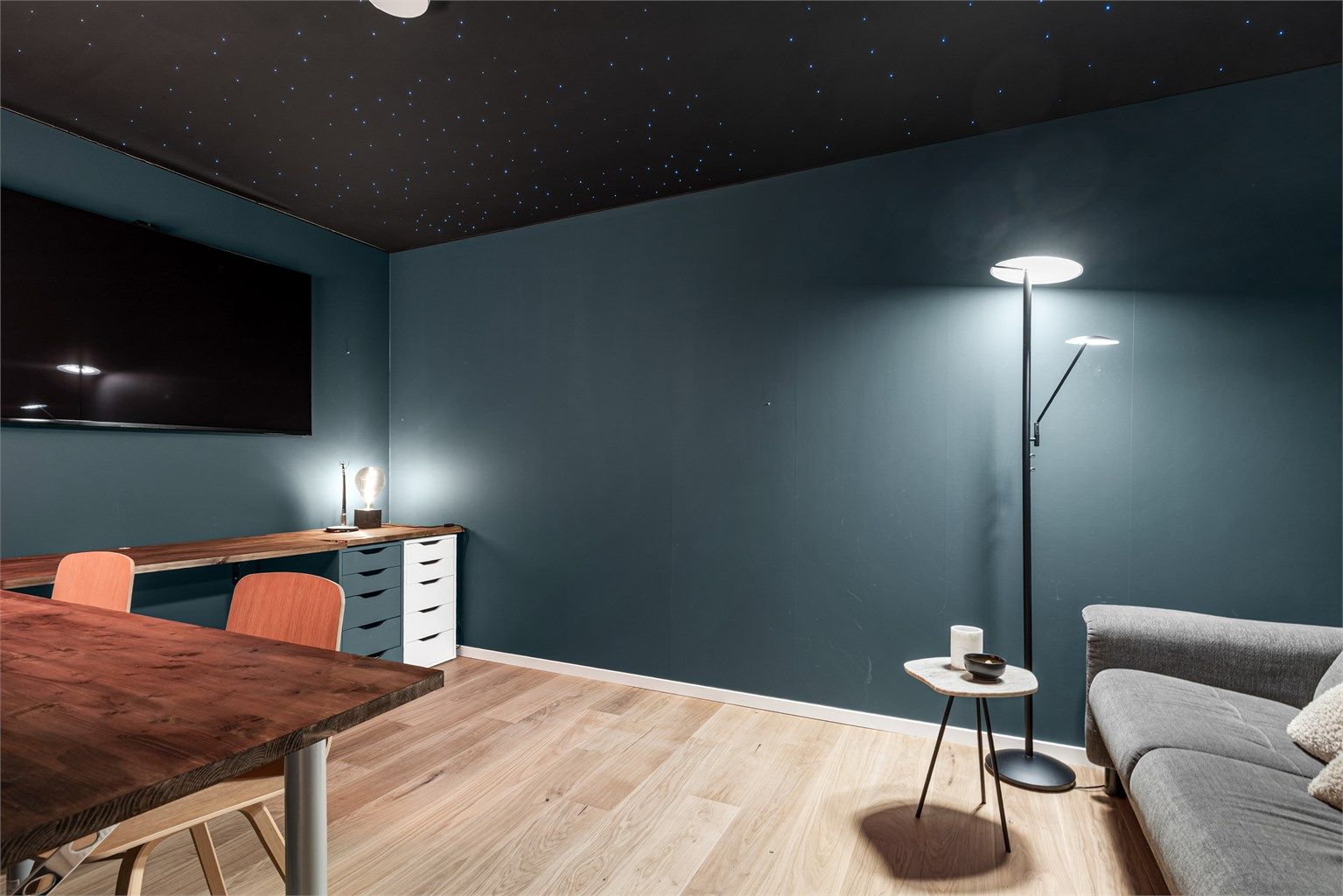 Stilig, moderne medierom med stjernehimmel og plass til sittegruppe og TV-område.