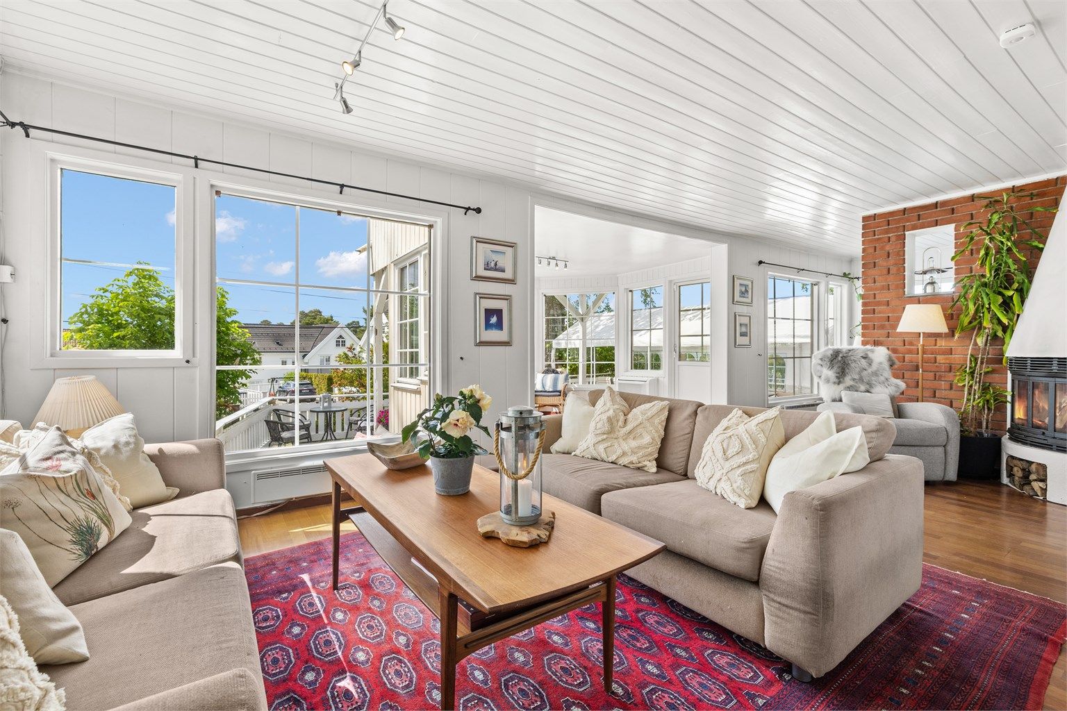 Lys stue med store vindusflater mot sydvest. Peis for ekstra varme og hygge