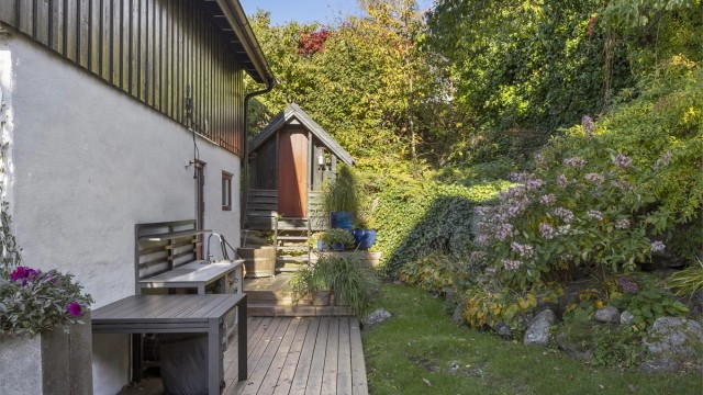 Mot nord er det en markterrasse på ca. 33 m² med utekjøkken og et praktisk vedskjul.
