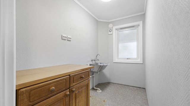 Separat vaskerom i 1. etasje med utslagsvask, opplegg for vaskemaskin og gulvvarme.